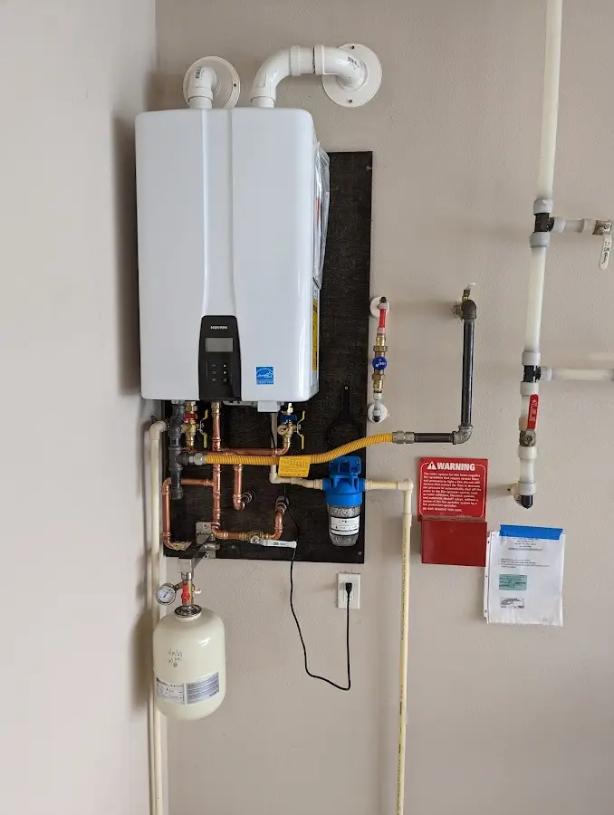 Professional plumber installing copper piping in a Augusta home